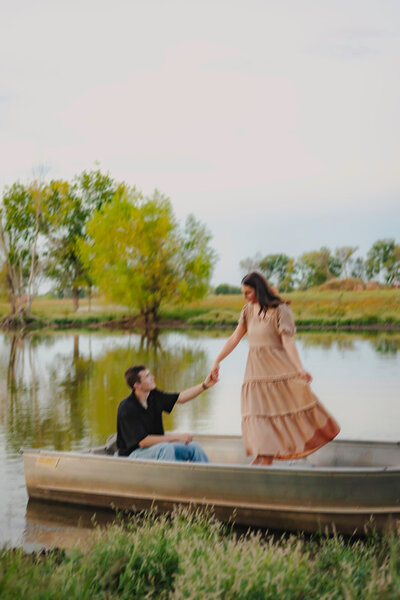 couple holding hands on row boat for couples session in okc
