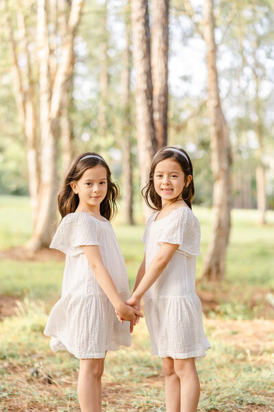 twins holding hands in a family friendly hiking trail in Sunnybank.