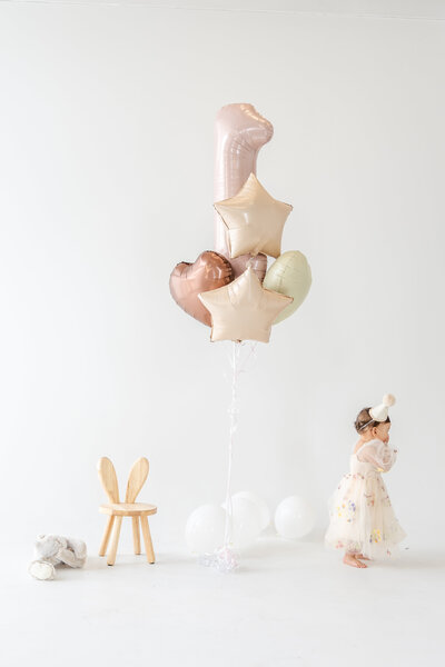 Baby girl celebrating first birthday with smash cake in Miami studio