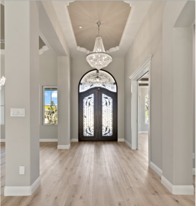 Luxury  Bakersfield home foyer entryway with chandelier and ornate door