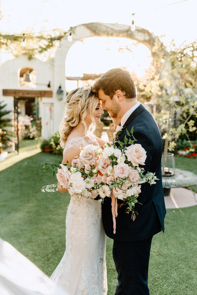 Bride and groom kissing at their wedding at Franciscan Gardens