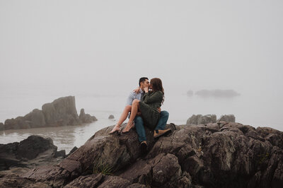 couple embracing on rocks