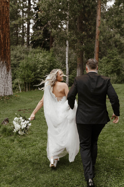 wedding couple running in lake tahoe