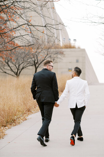 same sex black tie wedding couple photo outside of Kauffman Center for the Performing Arts