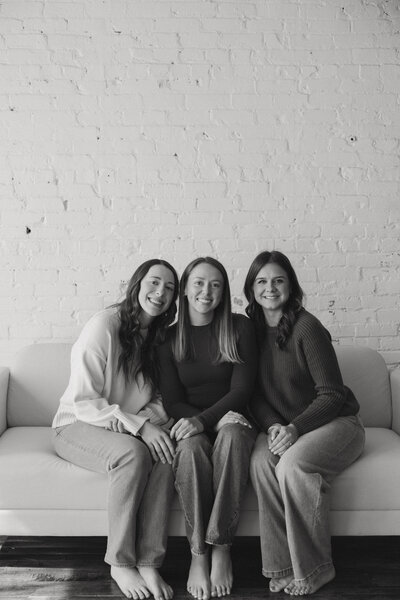 black and white portrait of sisters on couch Magnolia Tree Weddings| Wedding event planner 