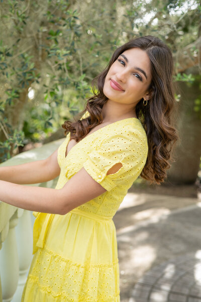 A senior photography in Orlando with a girl in a yellow dress at Leu Gardens in Orlando, Florida.