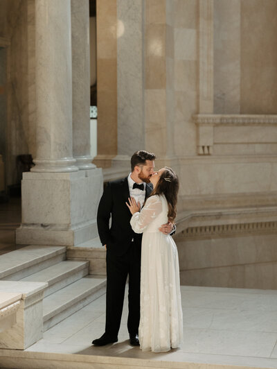 couple kissing on courthouse steps  elopement