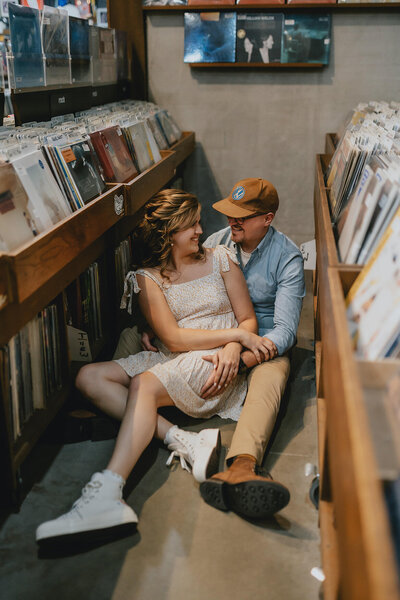 couple sits on record store floor