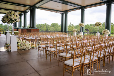 Chic wedding ceremony setup featuring gold chairs and natural lighting at a Raleigh wedding venue.