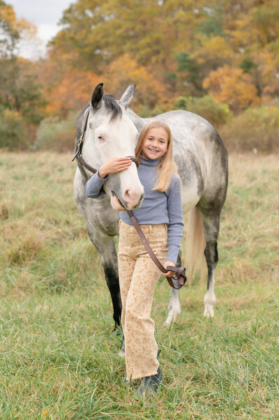 children standing in front of their horse