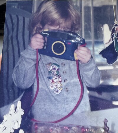 photo of photographer holding camera to her face