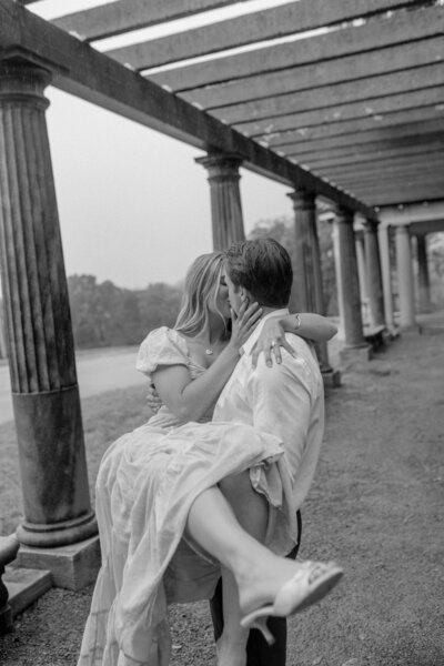 a man holding a woman while they kiss