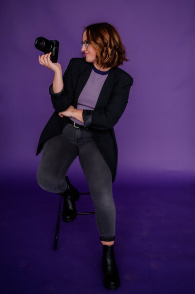 Woman poses for the camera with Nikon Z6II Camera in hand.
