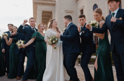a bride and groom kissing outside the Scottish Rite Cathedral