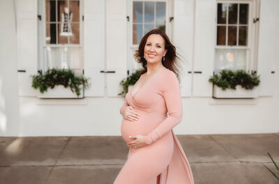 Pregnant woman embraces her baby bump during Maternity Photoshoot in Charleston, SC.