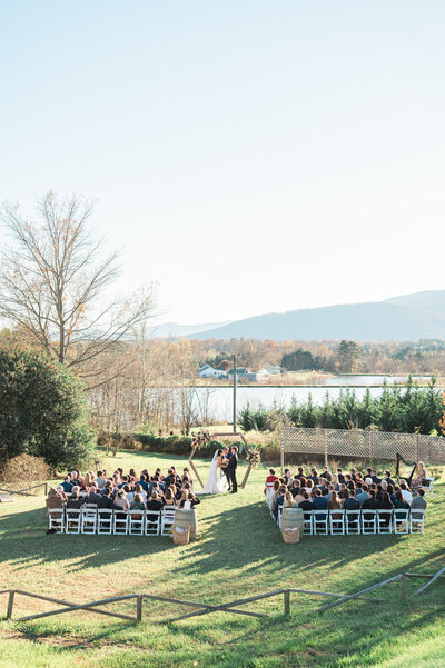 A wide view of a wedding ceremony outdoors