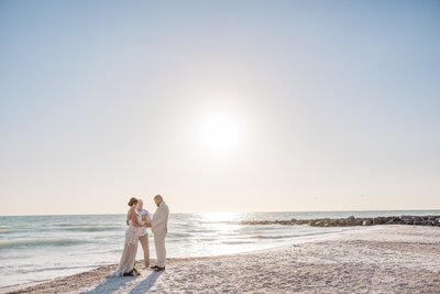 A romantic sunset elopement at Sunset Beach on Treasure Island, with breathtaking ocean views and a serene, sandy shoreline.