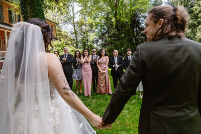 A couple smiles at one another as their families see them for the first time