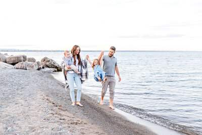 family with girl and small white dog