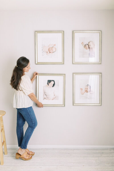 photo of Talia Laird Photography holding framed fine art prints that she custom framed for her Madison Wi newborn photography clients