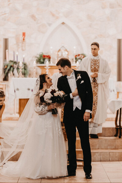 Bride and groom walking in a Catholic church