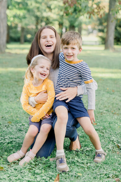 Mother and kids laughing during a family photoshoot in Philadelphia.