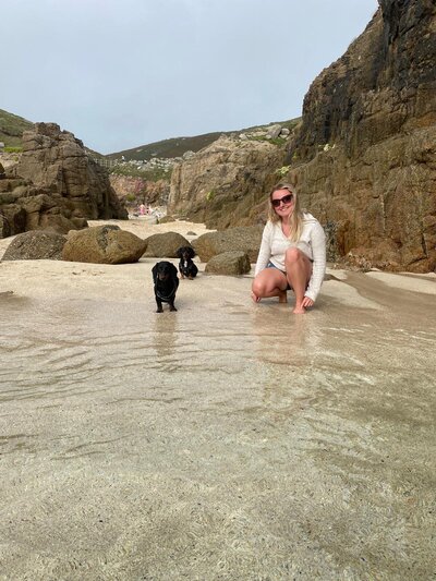 Amy on the beach with her two dogs