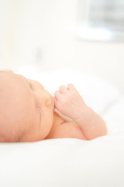 Newborn Baby laying on bed by Lawton Ok Photographer Courtney Cronin