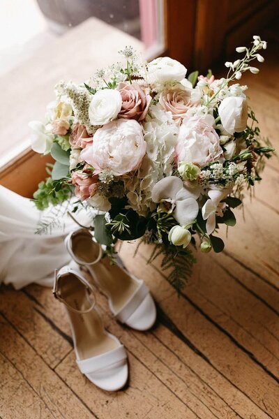 A bridal bouquet represents an example of wedding flowers designed by Flowers and Thyme.