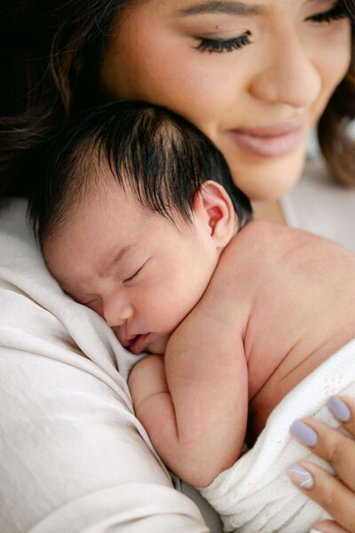 Bay area newborn photography of mom snuggling with newborn, taken by Laurel Smith Photography