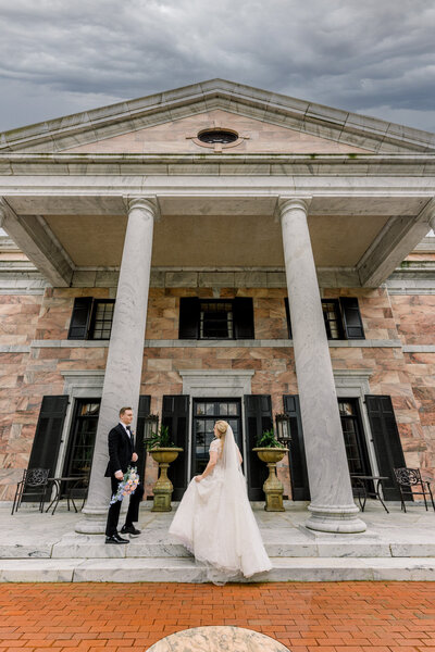 Bride and Groom standing in front of The Tate House