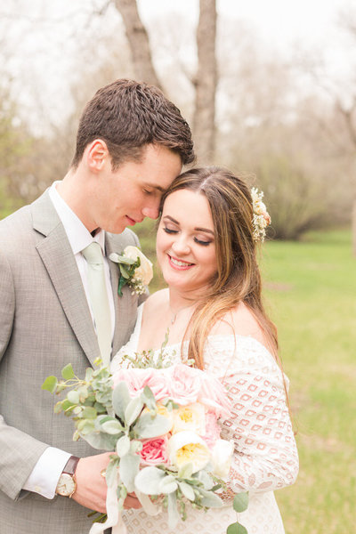 Bride and Groom sharing their first kiss during outdoor wedding