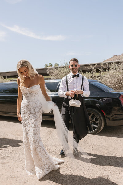 Arizona wedding photographer captures bride and groom getting out of limo at El Chorro wedding venue