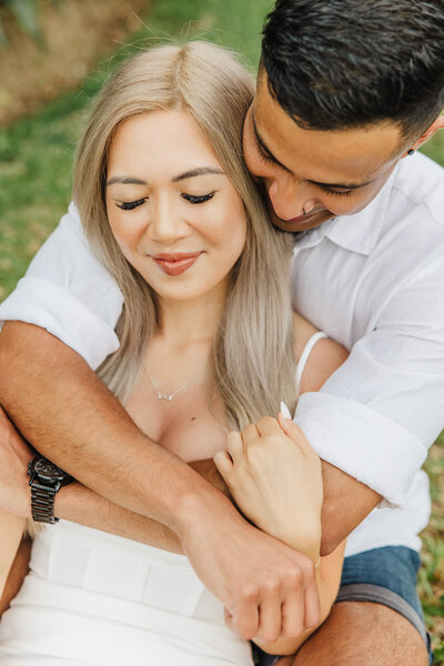 couple hugging on grass