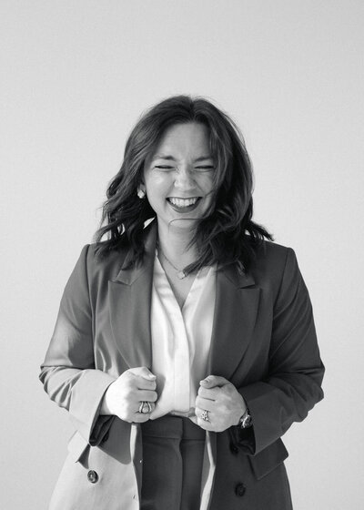 Portrait of Colorado wedding photographer Logan Ferree smiling in a studio.