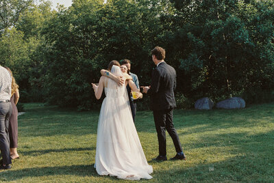 Bride and groom laugh together in front of their wedding venue
