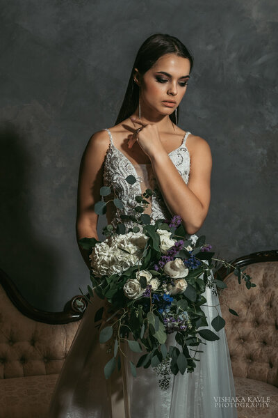 bride wearing wedding gown and holding bridal bouquet