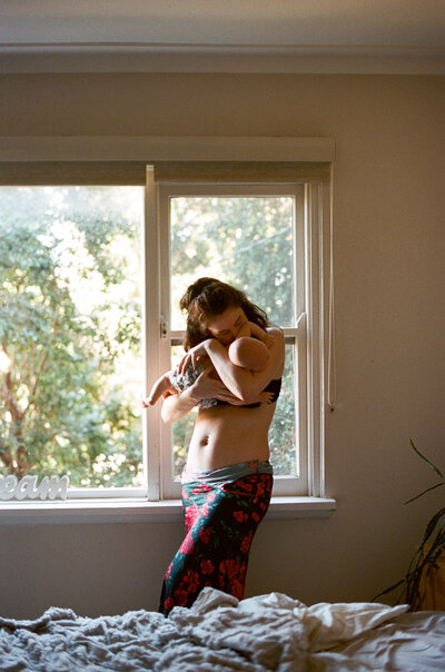 A sweet moment from a natural family photoshoot in Sydney celebrating a growing family