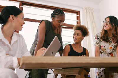 Female Entrepreneurs talking around a table about their business plan