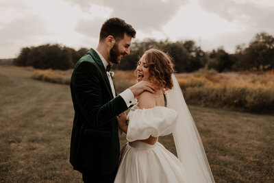 fall wedding couple laughing with playful touch candid photo