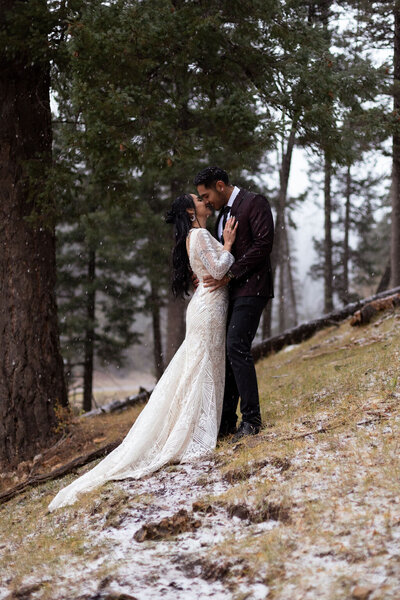 Couple during their winter forest elopement in Utah, captured by Lamblight Photography