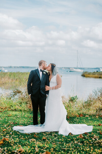 Bride and groom kissing on the lawn at CBMM