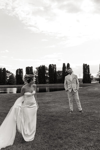 Black and White Documentary style candid photo of bride and groom looking at each other in Caledonia, MN 
