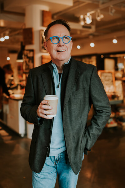 A relaxed portrait of a client in a cozy indoor scene by a window—projecting calm, authenticity, and emotional connection through photography.