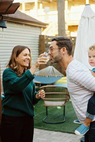Family embracing at home during a documentary-style photo session.