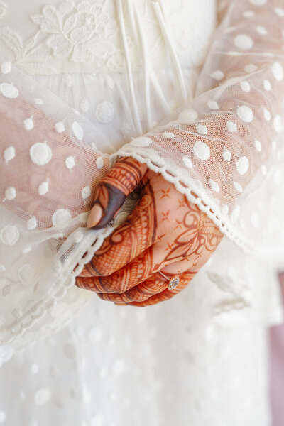 A close up of hands covered in henna tattoos 