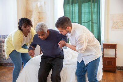 Man being provided support to stand up