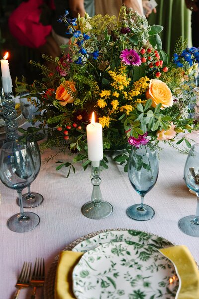 Wedding tablescape with colorful florals and glasses