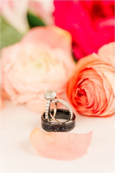 wedding photo wedding rings with flowers by wedding photographer Joni Loraine Photography
