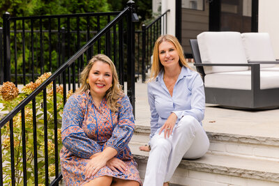 realtor team sitting on outdoor stairs during brand photoshoot with Laure Photography